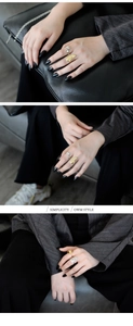 Detail view of irregular S925 silver rings with artistic face patterns in gold and silver