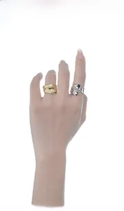 Close-up of gold and silver irregular textured rings with wavy edges on model fingers