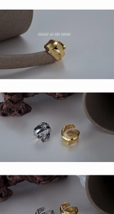 Macro detail of irregular wave texture on S925 sterling silver open rings in gold and silver