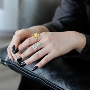Artistic S925 sterling silver rings with abstract face and rose floral motifs on black leather
