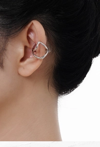 Close-up of a minimalist S925 sterling silver hollow line ear cuff worn on the ear