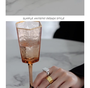 Detailed view of silver rectangular and gold wavy textured S925 sterling silver rings