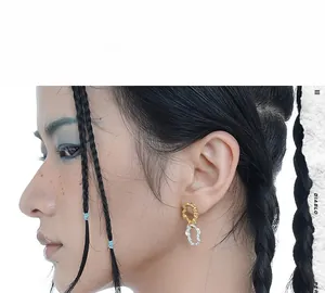 Detail of minimalist S925 silver earrings with gold and silver wrinkled texture