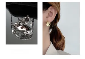 Macro detail of S925 sterling silver earrings featuring organic lava texture and model view