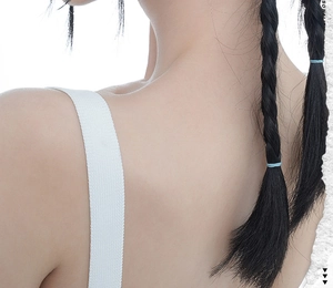 Detailed texture of minimalist knitted white straps on a stylish backless fashion piece