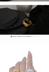 Detail of S925 silver ring with lava texture and red zircon accents in gold and silver