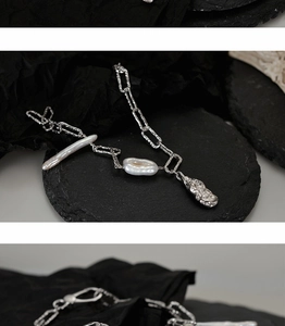 Close-up of S925 silver textured chain bracelet with white baroque pearls on stone tray