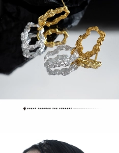 Macro detail of S925 silver earrings with irregular lava texture in gold and silver