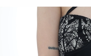 Detail of the black and white floral lace pattern and sleeve texture on women top