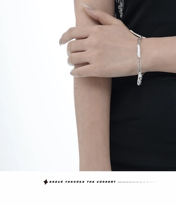 Close-up of S925 sterling silver chain bracelet with irregular baroque pearls on wrist