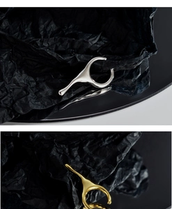 Detailed macro view of liquid metal ear cuffs in polished silver and gold finishes