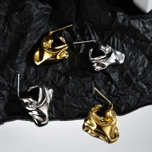 Abstract irregular lava texture stud earrings in polished gold and silver finishes