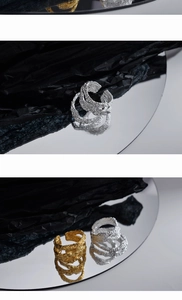 Detailed view of hollow irregular crinkle texture open rings in gold and silver finish