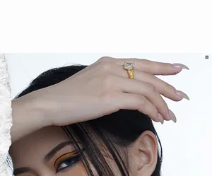Macro detail of S925 silver ring featuring gold texture and princess cut gemstone