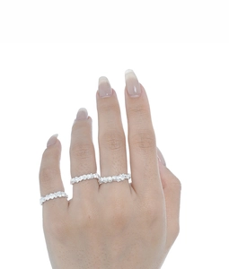 Close-up of three-piece S925 silver rings with irregular rock texture worn on fingers