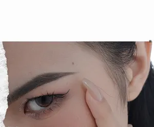Close-up of artistic makeup and nail art reflecting vintage jewelry aesthetic