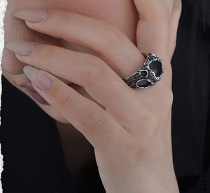 Macro detail of S925 sterling silver ring with rustic rock texture and asymmetric hollows