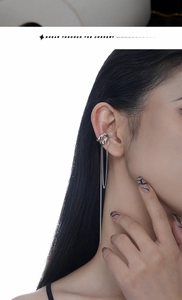 Close-up of S925 sterling silver ear cuff with long tassel chain and zircon on female ear