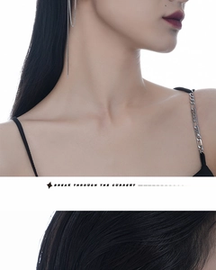 Detail of silver S925 sterling silver tassel earrings with delicate hanging chains