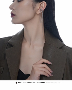 Detail of silver tassel chain ear cuff showing double layer hollow design on model