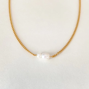 Detail of minimalist gold chain necklace with two baroque pearls in various sizes