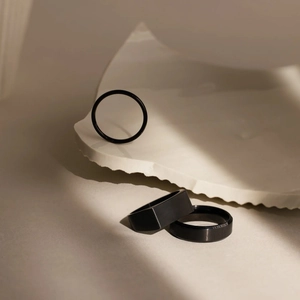 Three-piece set of minimalist black stainless steel rings with matte and polished finishes
