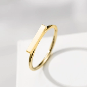 Minimalist 316L stainless steel gold geometric bar ring on a clean white display stand