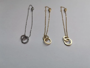 Detailed view of double circle necklaces in silver, gold, and rose gold with hammered texture