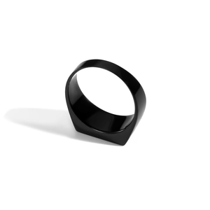Close-up of a minimalist black signet ring with a polished square top and mirror finish