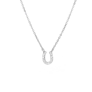 Detailed close-up of a silver horseshoe pendant featuring a unique hammered texture finish