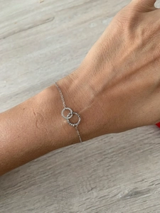 Close-up of minimalist double interlocking rings bracelet with unique hammered texture