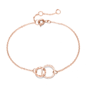 Detail of rose gold double interlocking hammered rings on a dainty O-chain bracelet