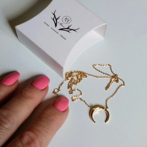 Golden crescent moon pendant necklace with white jewelry gift box and sleek snake chain