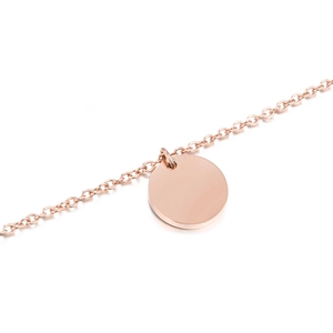 Close-up of polished rose gold round pendant necklace with mirror finish cable chain