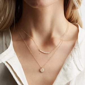Double layer gold stainless steel necklace with small white beads and round pendant