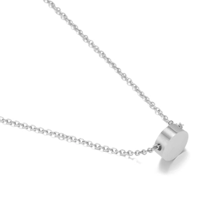 Detailed view of a polished silver stainless steel cylindrical pendant on a fine chain link