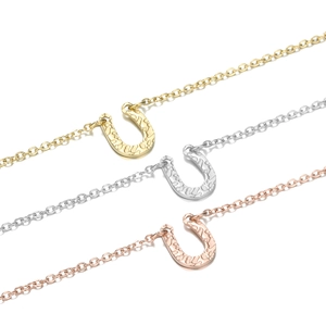 U-shaped horseshoe pendant necklace in gold, silver, and rose gold with hammered texture