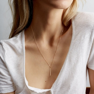 Minimalist gold bar pendant necklace for women on neck for a lightweight jewelry look