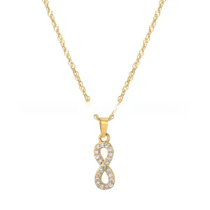 Close-up of gold infinity pendant necklace featuring micro-set sparkling crystals