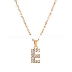 Detailed close-up of golden alphabet E pendant with shimmering crystals on a twisted chain