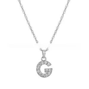 Macro view of silver-tone letter G necklace pendant with sparkling paved rhinestones