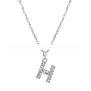 Detailed view of silver stainless steel water wave chain with iced out letter H pendant
