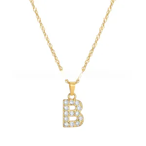 Detailed view of golden pendant necklace featuring letter B set with sparkling crystals