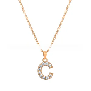 Macro shot of rose gold letter C pendant paved with white cubic zirconia on chain