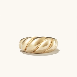 Close-up of polished gold-plated stainless steel croissant ring with twisted texture