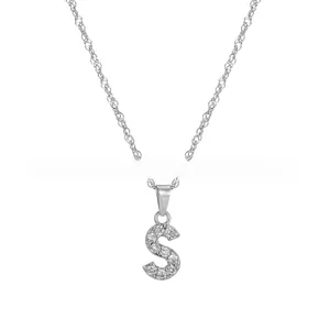 Close-up of silver-tone S-shaped letter pendant necklace with sparkling micro-pave crystals