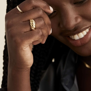Croissant gold-plated stainless steel dome ring with textured twist design on model finger