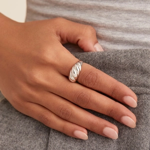 On-hand display of a silver twisted croissant ring with minimalist French vintage style