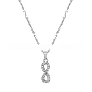 Macro shot of sparkling infinity symbol pendant with pave-set crystals on a silver chain