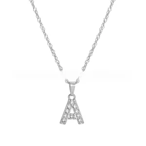 Close-up of silver-tone letter A pendant with sparkling pavé-set stones on twist chain
